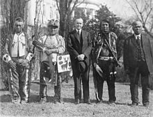  	  President Coolidge stands with four Osage Indians at a White House ceremony.